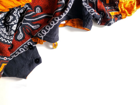 Colorful patterned fabric with ethnic batik design crumpled on an isolated white background with copy space.