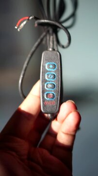Detailed view of electronic device controller switch with light intensity plus minus buttons.	