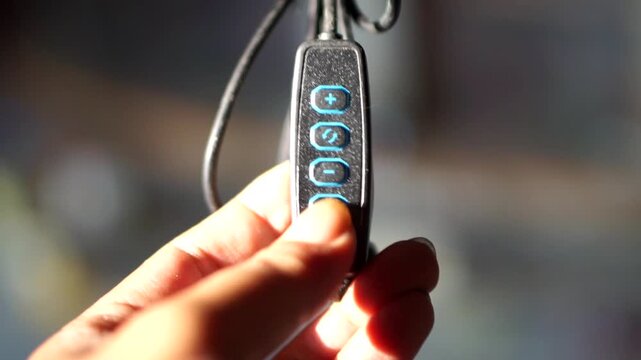 Detailed view of electronic device controller switch with light intensity plus minus buttons.	