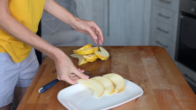 Person slicing fresh yellow melon on wooden cutting board in home kitchen video Full HD preparation