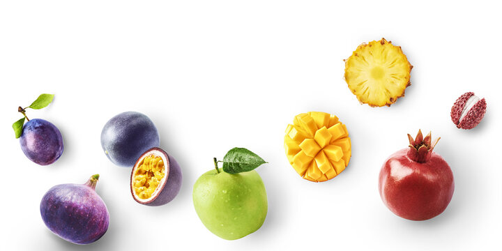 Flat lay of fresh fruits with hard flash shadow isolated on a white background. Lychee, pineapple, pomegranate, mango, apple, passion fruit, fig and plum bottom border with copy space.