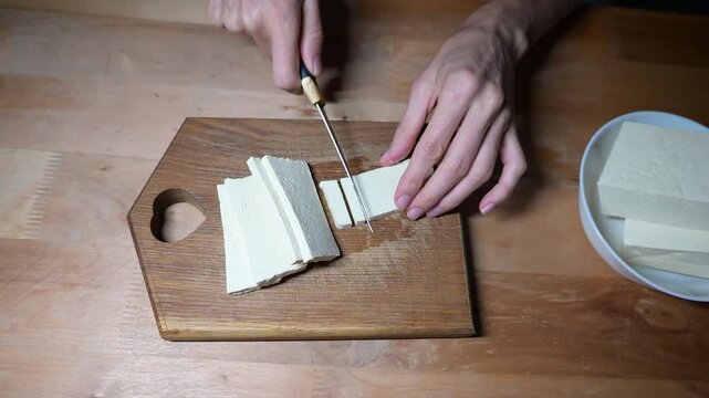 Preparing vegan tofu and tomato salad with fresh herbs in home video Full HD kitchen