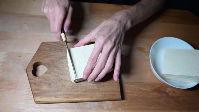 Preparing vegan tofu and tomato salad with fresh herbs in home kitchen video Full HD