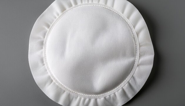 white circular fabric patch with textured surface on gray background