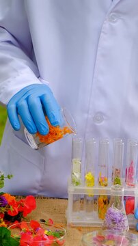 Flowers and test tubes for perfume making. Selective focus.
