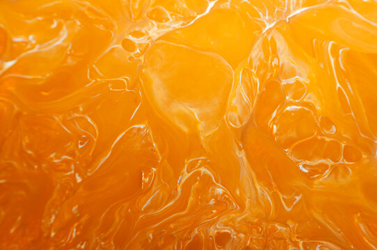 Orange jelly displayed in a close view shows its shiny texture and bright color