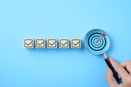 Business Strategy Planning and Quality Management Concept. Magnifying glass focuses on target icon and blocks with check marks. business goal setting, strategy planning, quality management processes,