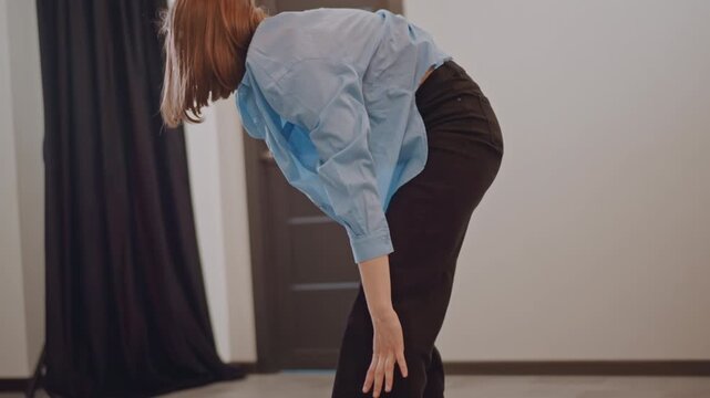 Solo practice in studio with fluid legwork and controlled balance, dancer exploring improvisation and weight shifts, minimal props, soft lighting and empty space creating focused training atmosphere