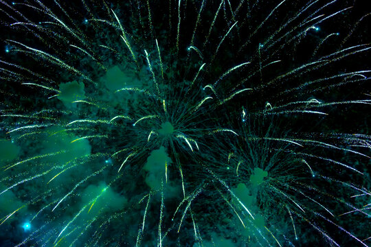 Fireworks close-up. Multicolored fireworks in the night sky, bright festive background with space for text.
