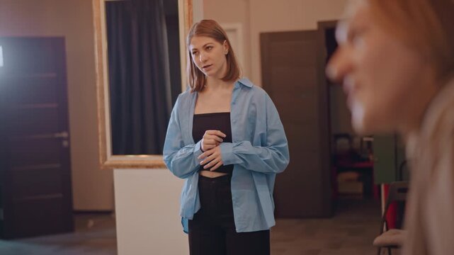 Student singer rehearsing in studio, focused practice with vocal coach energy, warm lighting, casual blue shirt, microphone and camera setup, quiet classroom atmosphere with attentive peers