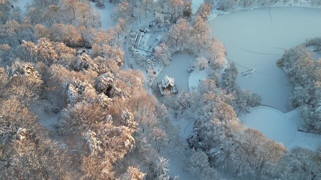 Cinematic aerial view of Thai-Sala pavilion in snowy Westpark Munich Germany.