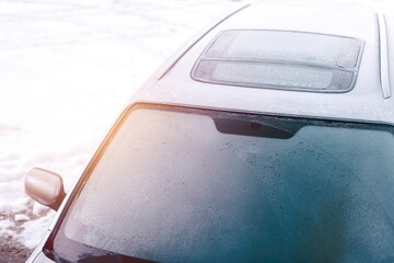 Hoarfrost on frozen car glass in cold season © AlexGo