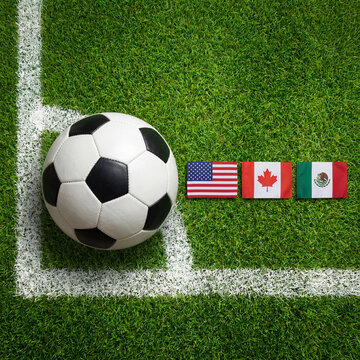 Soccer ball on a field with usa canada and mexico flags