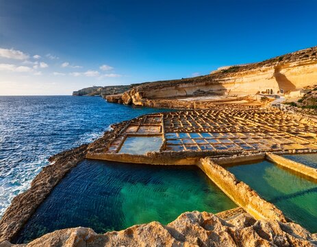 characteristic coastal landscape with natural rock shapes and historic salt pans near zebbug gozo malta