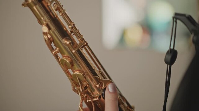 White band student testing saxophone tone in rehearsal, closeup of body and mouthpiece, careful breath and intonation checks, school ensemble practice mood with focused preparation