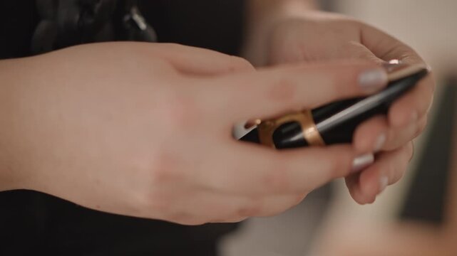 Closeup hands attaching clarinet ligature and mouthpiece in warm studio music teacher prepping reed with steady fingers, neat manicure visible, focused adjustment for optimal tone, slow deliberate