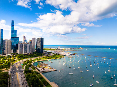  Aerial drone view of Chicago skyline and Lake Michigan lakefront with sailboats, St. Regis Chicago tower, Lake Shore Drive, and Burnham Harbor&rdquo;
