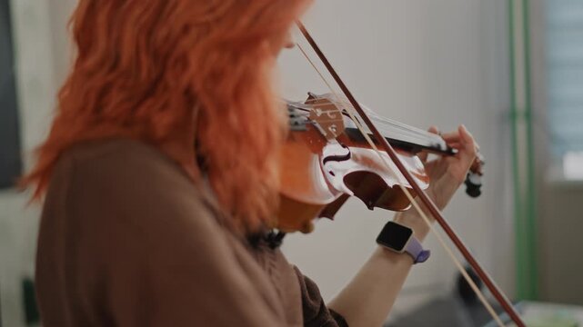 Caucasian violin teacher warmup in studio, red hair closeup of bowing technique and finger placement, calm natural light, intimate educational atmosphere, teacher demonstrating posture and tuning,