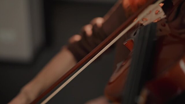 Caucasian violin coach demonstrating bow technique closeup, detailed views of hand grip and motion, posture adjustment and finger placement, steady rhythm emphasis, instructional school atmosphere