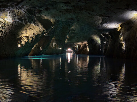 Saint-L&eacute;onard, Valais, Switzerland - May 02, 2026: Ancient Rocky Cave Walls Surrounding the Serene Turquoise Underground Lake at Lac Souterrain de Saint-L&eacute;onard