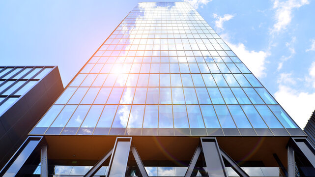 Steel and glass. The subject of modern architecture or construction industry. Modern office building facade with tall steel construction elements and full height windows between.
