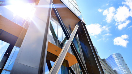 Naklejka premium Steel and glass. The subject of modern architecture or construction industry. Modern office building facade with tall steel construction elements and full height windows between.
