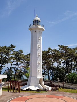 Ulsan, South Korea, April 18, 2026: Ulgi Lighthouse at Ulsan Daewangam Park with a Forest Trail Leading to Coastal Red Rock Formations, Iron Bridge, Observation Tower  울산 대왕암 울기등대 공원

