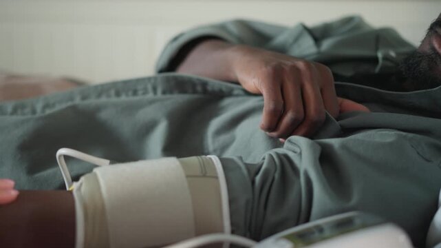 Resting during checkup. Peaceful bedside health assessment. Serene scene of patient receiving care at home. Quiet and tranquil scene of individual resting during health examination at home