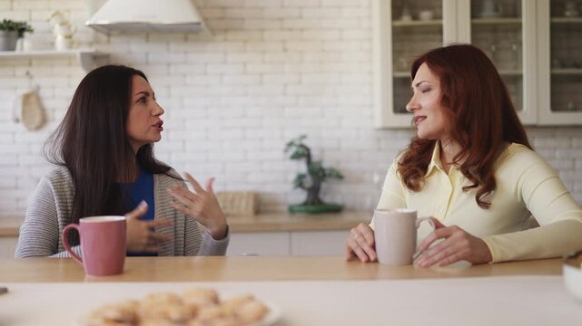 Middle-aged woman sharing a story with her best friend, trusted relationship