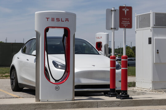 Tesla EV electric vehicle at a supercharger. Tesla models include the Cybertruck, Model 3, Model Y, Model X and Model S.