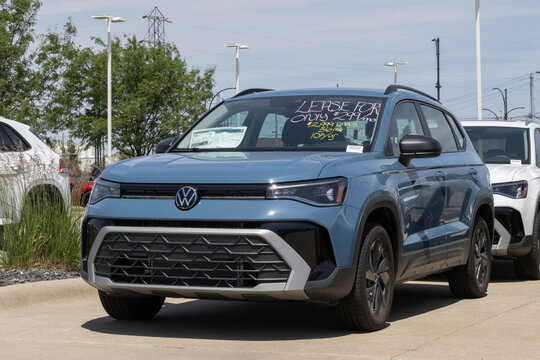 Volkswagen Taos S Black compact SUV at a dealership. VW offers the Taos with a 1.5L TSI Turbo 4-Cylinder engine. MY:2026