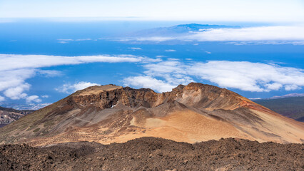 Naklejka premium Aerial high angle view of the massive volcanic caldera crater, desert badlands, and ancient lava fields in Teide National Park.