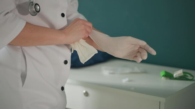 Doctor prepares for visit. Medical professional gets ready calmly. Healthcare worker prepares equipment for appointment. Physician dons gloves and arranges supplies before patient examination