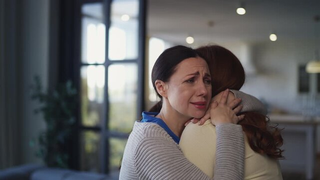 Sorrowful middle-aged woman embracing her female friend, emotional farewell
