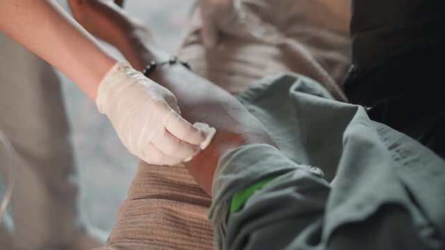 Healing after injury. Medical care during recovery process. Patient receives treatment from caring medical staff. Healthcare professional carefully applies sterile dressing to wound