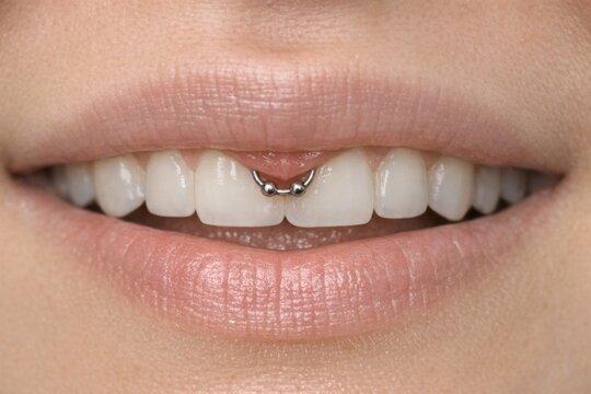 A detailed view of someone's mouth featuring a piercing, ideal for use in designs related to body modification or personal expression