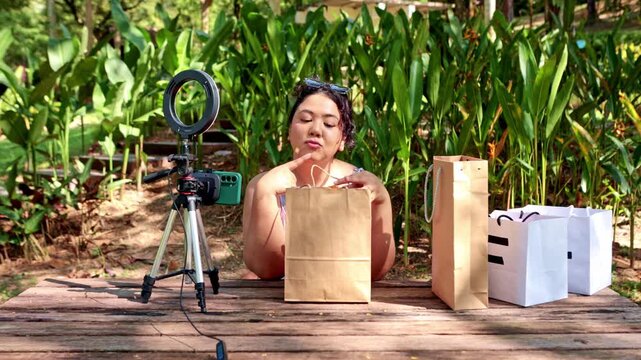Influencer vlogging about a recent shopping haul outdoors