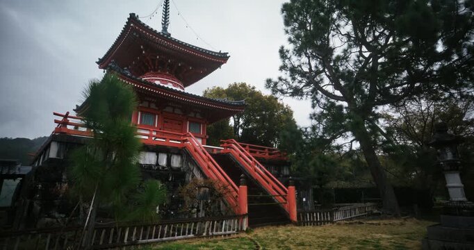 Rain falling in front of old Japanese shrine - dolly in shot
