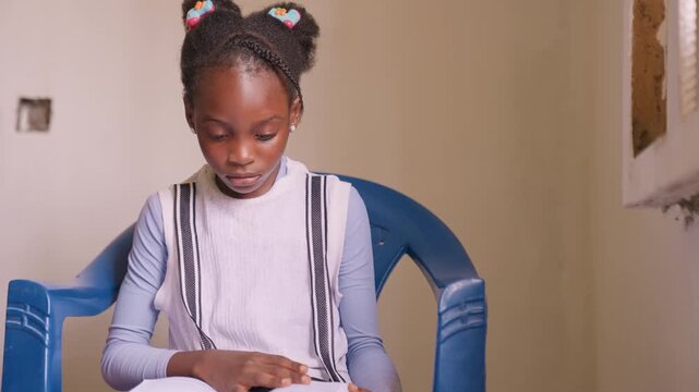 Concentrated black daughter tracing lines in book, quiet room ambiance, steady finger following text, patient expression, practicing pronunciation and vocabulary, indoor natural light