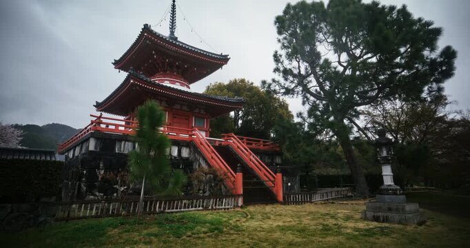 Rain falling on old, beautiful, red, Japanese shrine - steady cam forward shot