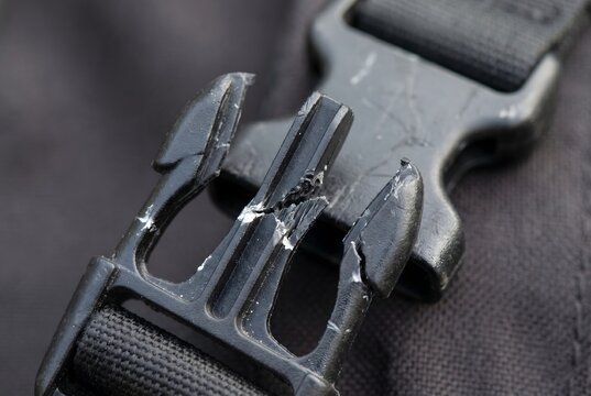 Full frame texture of snapped heavy-duty plastic backpack side release buckle
