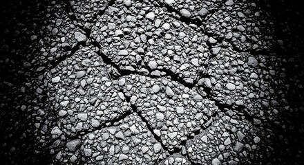 Naklejka premium Dramatic Black and White Texture of Cracked Asphalt Pavement with Small Stones Deep Fissures and Dark Vignette for Moody Abstract Background