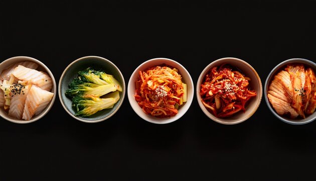 top down view of different bowls of kimchi