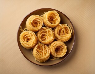 Fototapeta premium overhead layout of round noodle nests on a neutral background texture