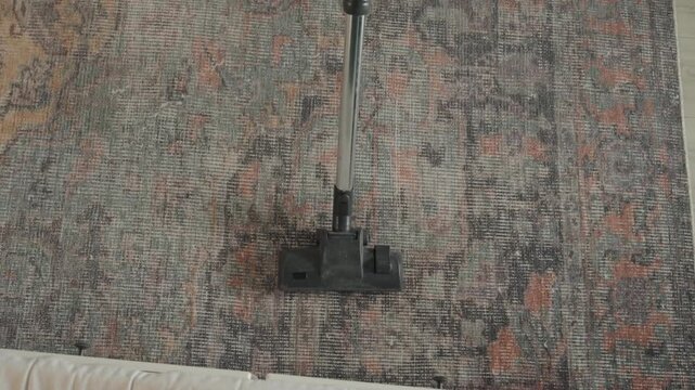 Deep clean pattern removal showcase. Closeup of vacuum removing stains from textured fibers. Steady motion shot illustrating deep cleaning process on textured rug with satisfying transformation