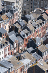 Obraz premium Views of Le Treport, seaside resort in Normandy, France, with white cliffs along English Channel, fishing industry and old buildings, travel destination in France, houses roofs background