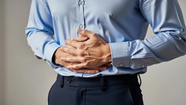 Abdominal Pain: A man in business attire clutches his stomach, indicating discomfort and potential gastrointestinal distress, highlighting a common health concern.