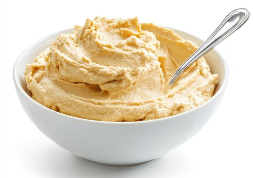 Creamy Hummus in a White Bowl with a Spoon.