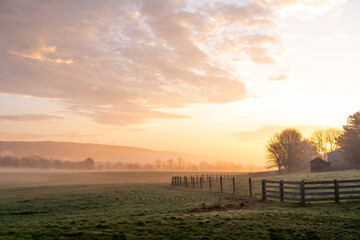 Misty Golden Sunrise Over Frost-Covered Rural Pasture © World Travel Photos