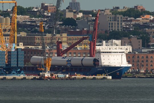 New York, NY, USA - May 30, 2026: Sections of offshore wind turbine towers on the vessel UHL Felicity in New York.